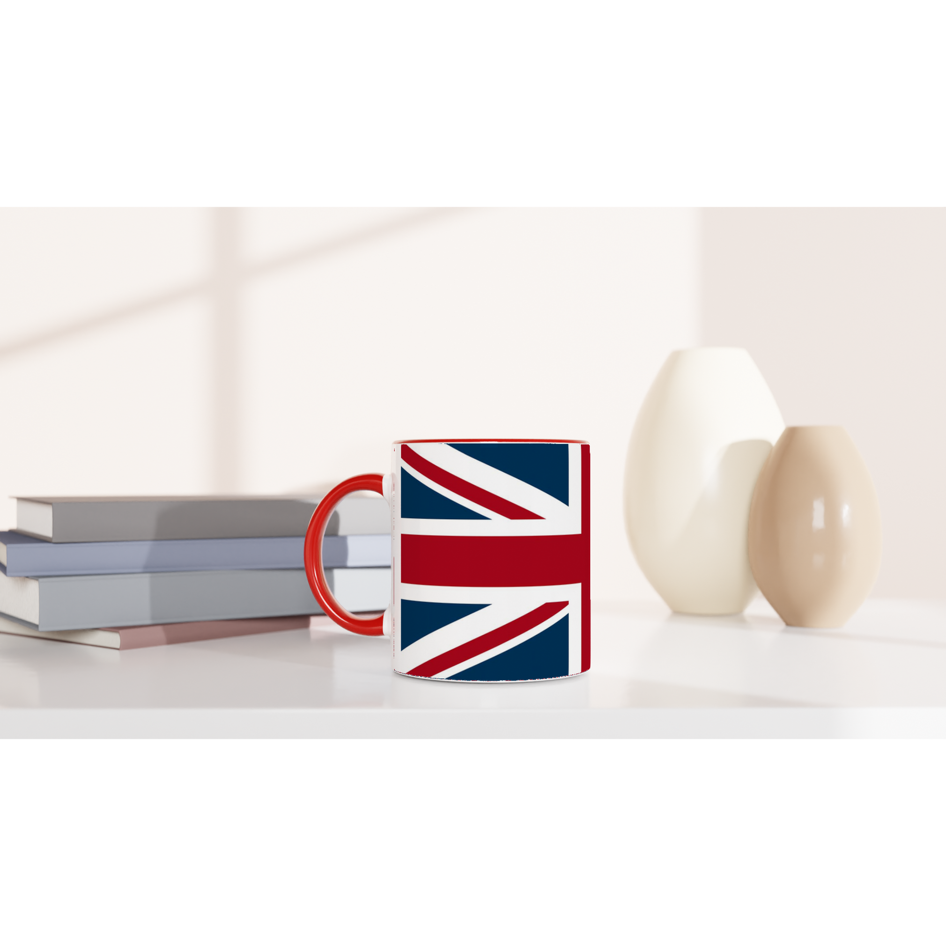 Mug with Union Jack design on a white surface with books and decorative items.